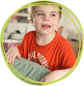 Little boy in orange t-shirt visiting Children's Hospice South West