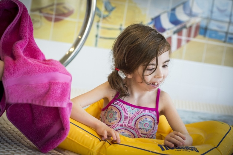 Little girl in the hydrotherapy pool at Little Bridge House
