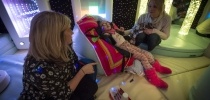 Little girl in sensory room with mum and carer thumbnail