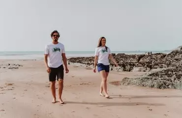 Two people walking on a beach