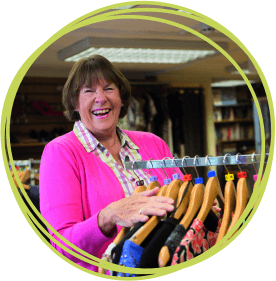 Similing woman working in CHSW charity shop