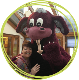 Sally with a hippo mascot at Little Bridge House