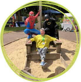 Sally with Spiderman and Batman at the summer fete