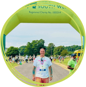 Volunteer underneath inflatable race finish line