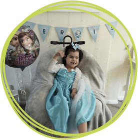 A little girl in a princess dress at home.