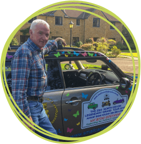 Terry Baker with his beloved Mini at Children's Hospice South West's Little Bridge House hospice in North Devon