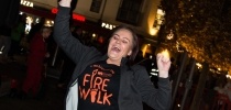 A Firewalk event participant smiling with hands in the air thumbnail