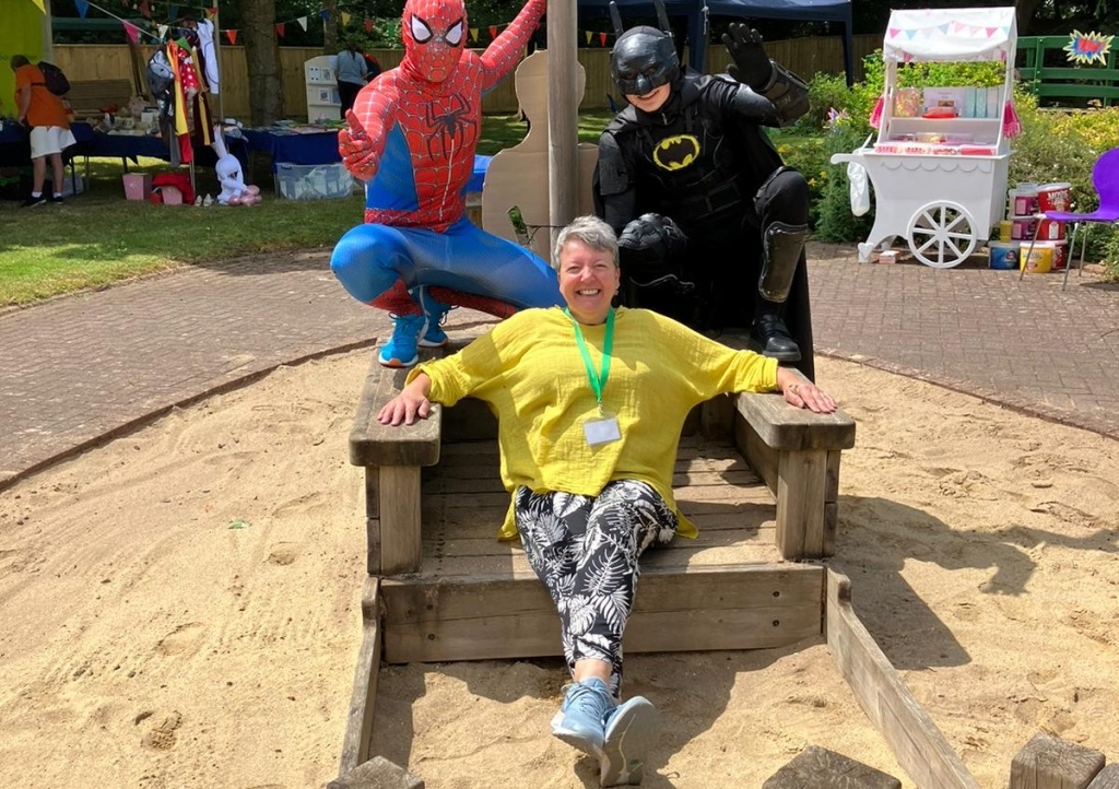 Sally with Spiderman and Batman at the summer fete