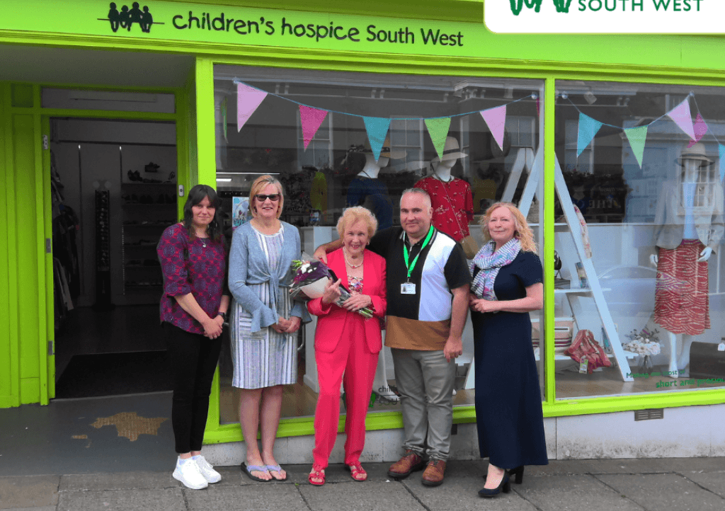 Pearl being presented flowers outside the Helston CHSW shop