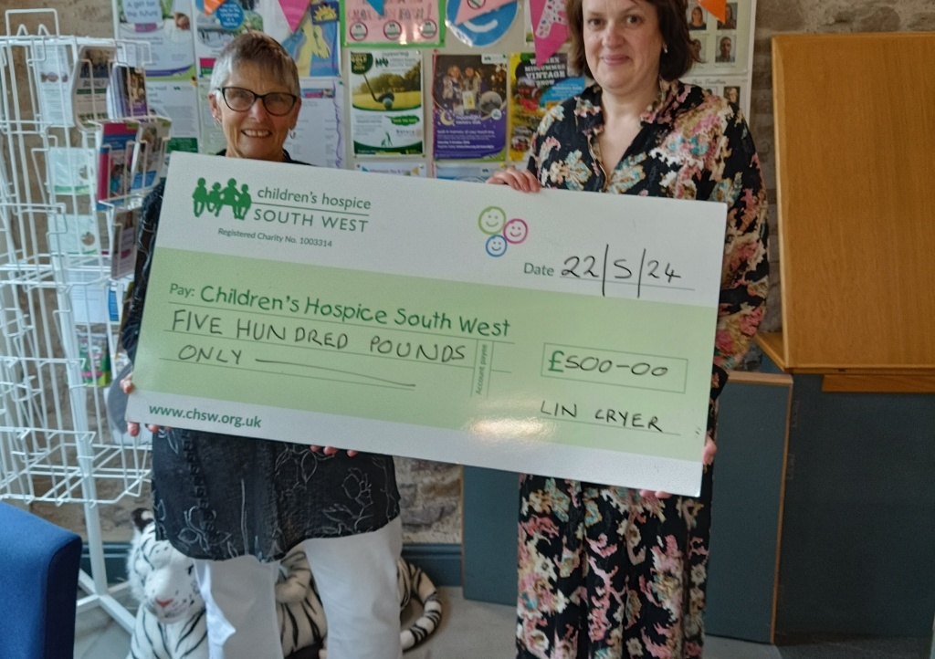 Fundraiser Lin Cryer hands cheque for £500 to Bath and North East Somerset and West Wiltshire area fundraiser Heidi Roberts