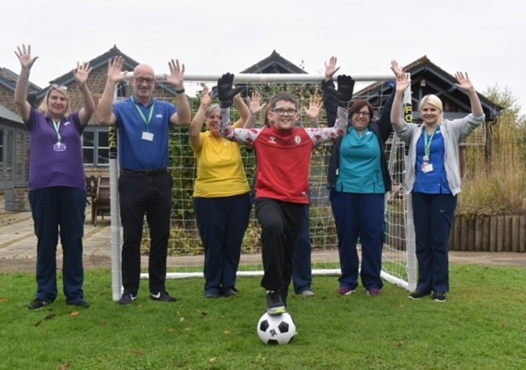 Young boy with hospice staff at Charlton Farm