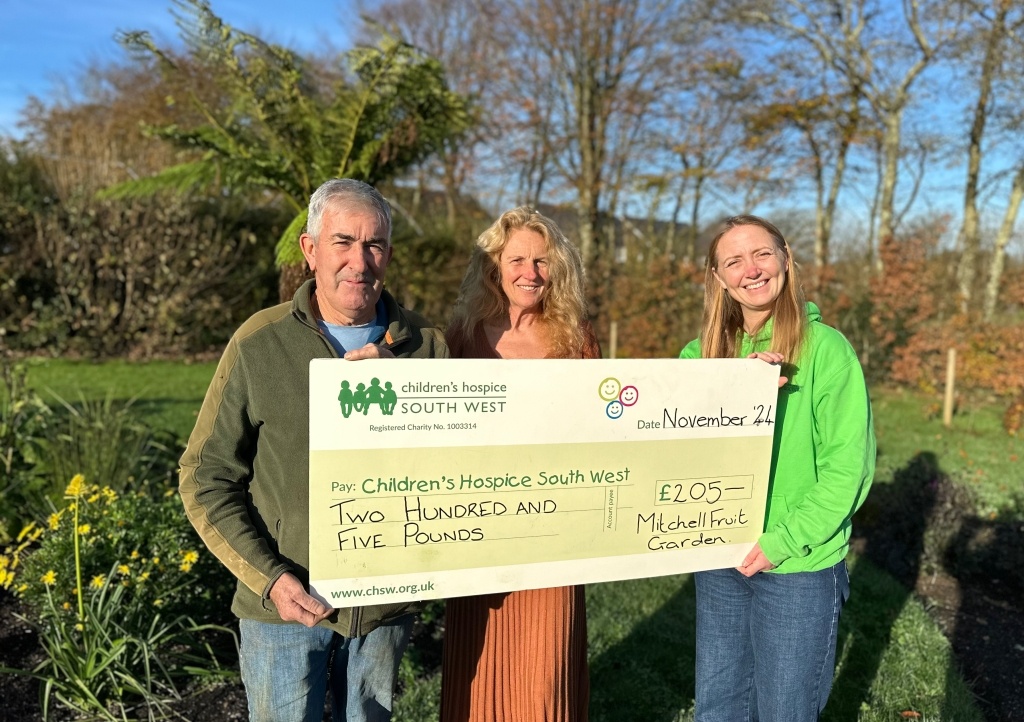 Alice presenting a cheque to Mitchell Fruit Garden