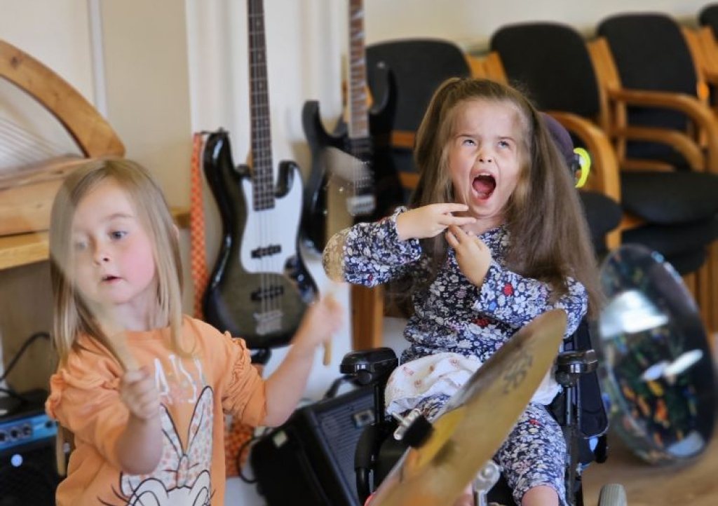 Two sisters in a music therapy session
