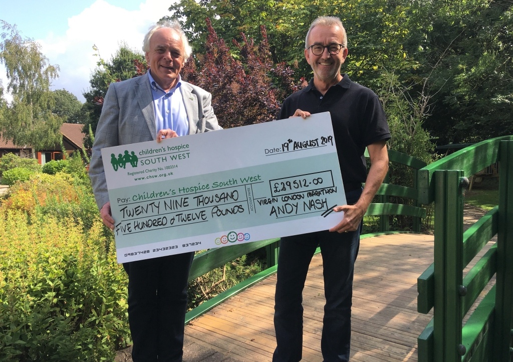 Andy Nash presents his fundraising cheque to Children’s Hospice South West co-founder and chief executive Eddie Farwell at Little Bridge House