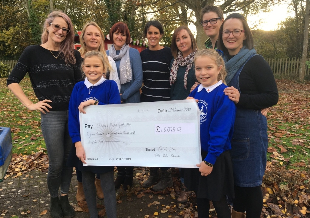 Jenny Pichowski, daughter Maisie, school friend Sophia White, and Dartmouth Amateur Rowing Club members Jo Langmead, Anna Lloyd, Ali McGrigor, Natasha Knight, Emma Alderman and Chrissy Rugg visit Little Bridge House to hand over the cheque for £18,075.62