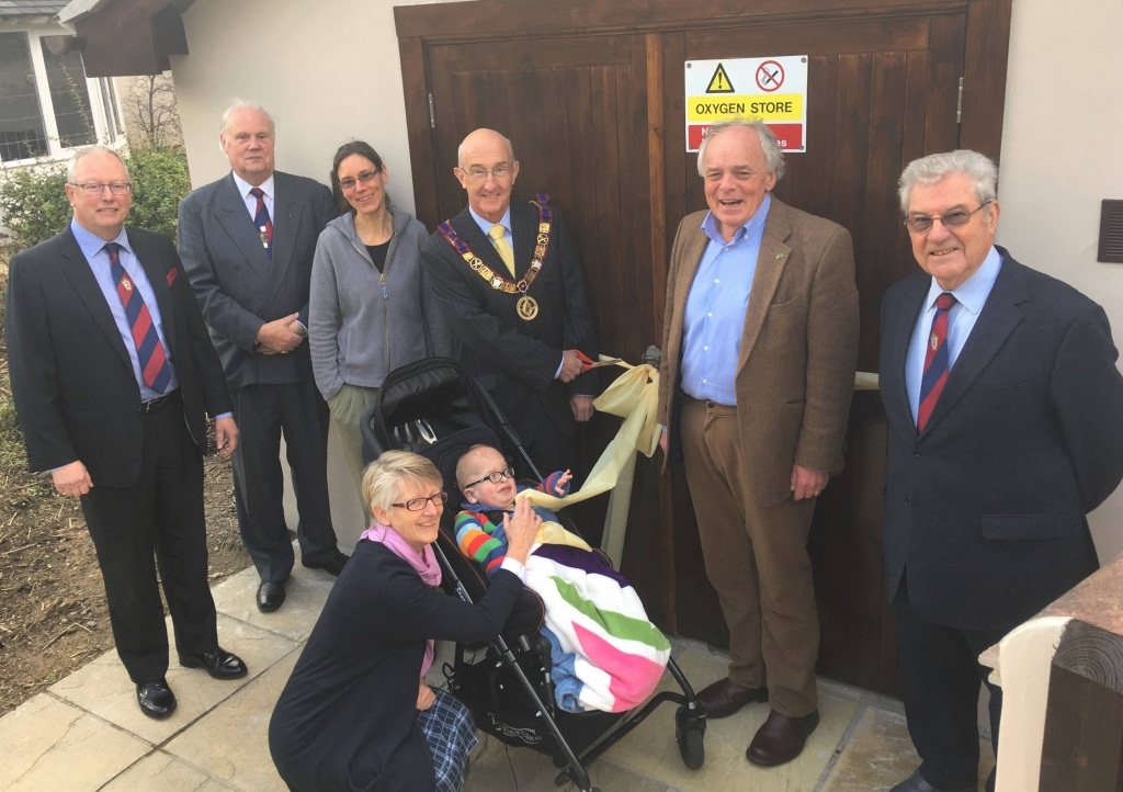 Peter Balsom cuts the ribbon with Henry Dunn, aged 4, watched by fellow Masons Trevor Jenkins, Brett Varker and Paul Howard-Baker, CHSW Chief Executive Eddie Farwell and head of care Tracy Freame.
