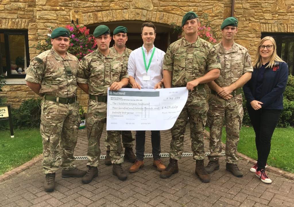 Sergeant Joe Long and colleagues from 1 Assault Group present a fundraising cheque to Children’s Hospice South West community fundraiser Josh Allen at the charity’s Little Bridge House