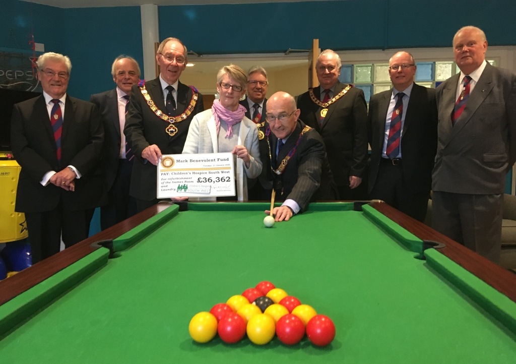 Peter Balsom and members of the Mark Master Masons of Devonshire officially open the new-look games room at Little Bridge House with CHSW Chief Executive Eddie Farwell and Head of Care Tracy Freame