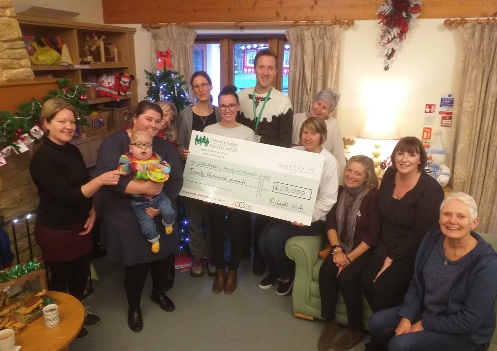 Rachel Cridge and Henry Dunn present the £20,000 fundraising cheque to the team at Little Bridge House during their stay in December