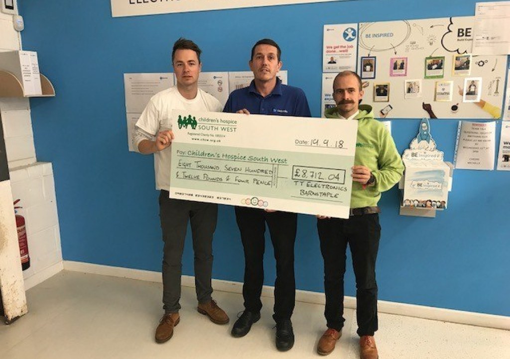 Jason Legg of Aero Stanrew presents a cheque for £8,712.04 to Children’s Hospice South West fundraisers Josh Allen and Dominic Scotting