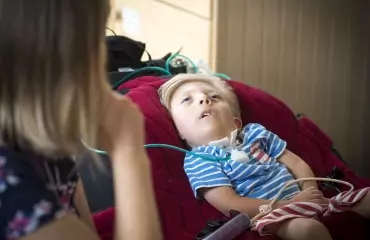 Boy being tub fed